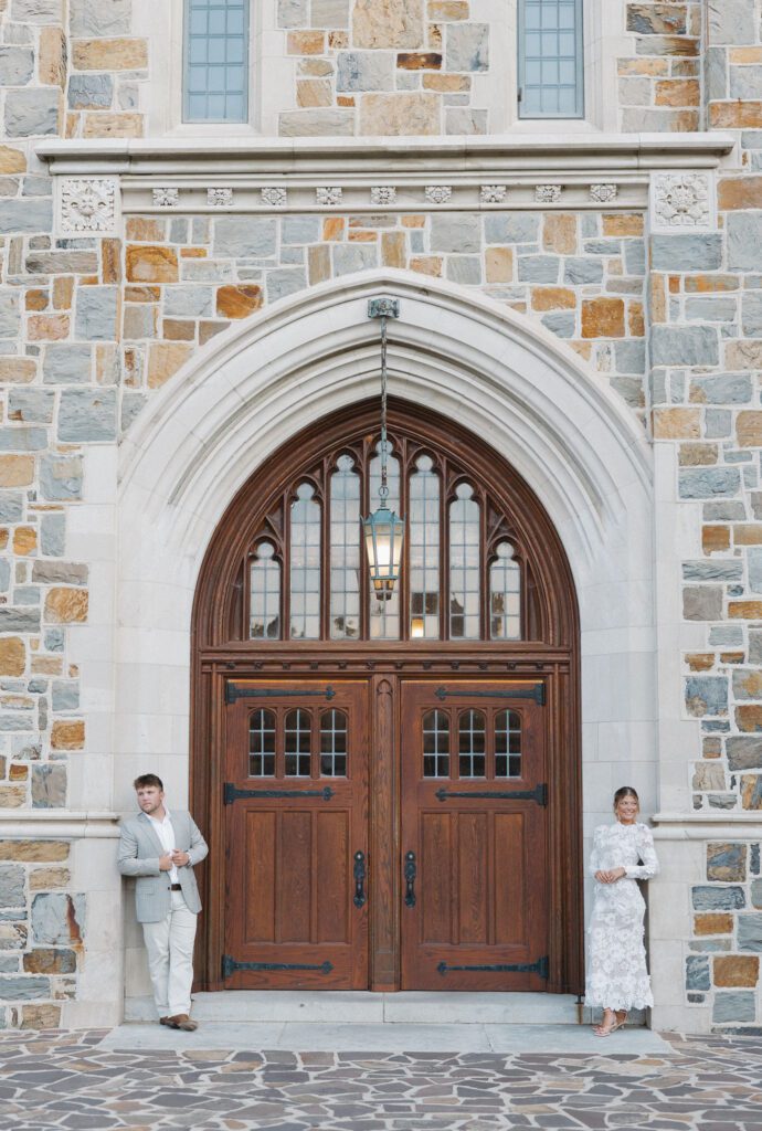 soon to be bride and groom standing of the sides of the doorway at berry college