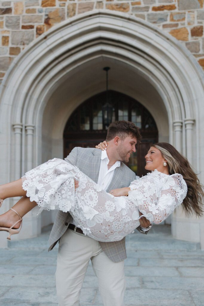 fiance holding soon to be wife in the bridal pose at berry college