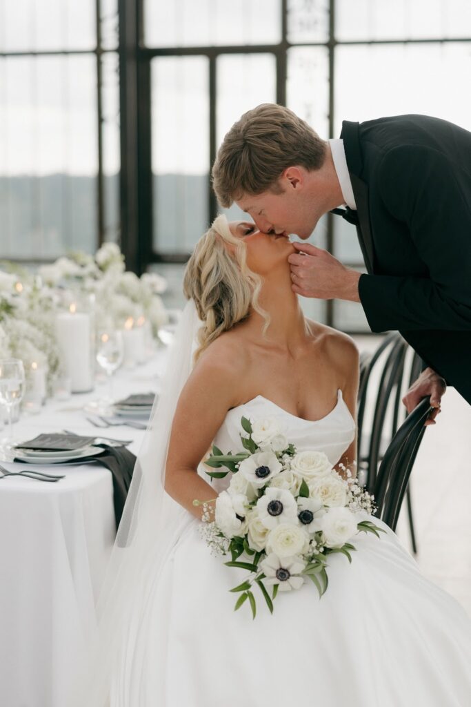 bride looking up to kiss her groom at stone haven weddings
