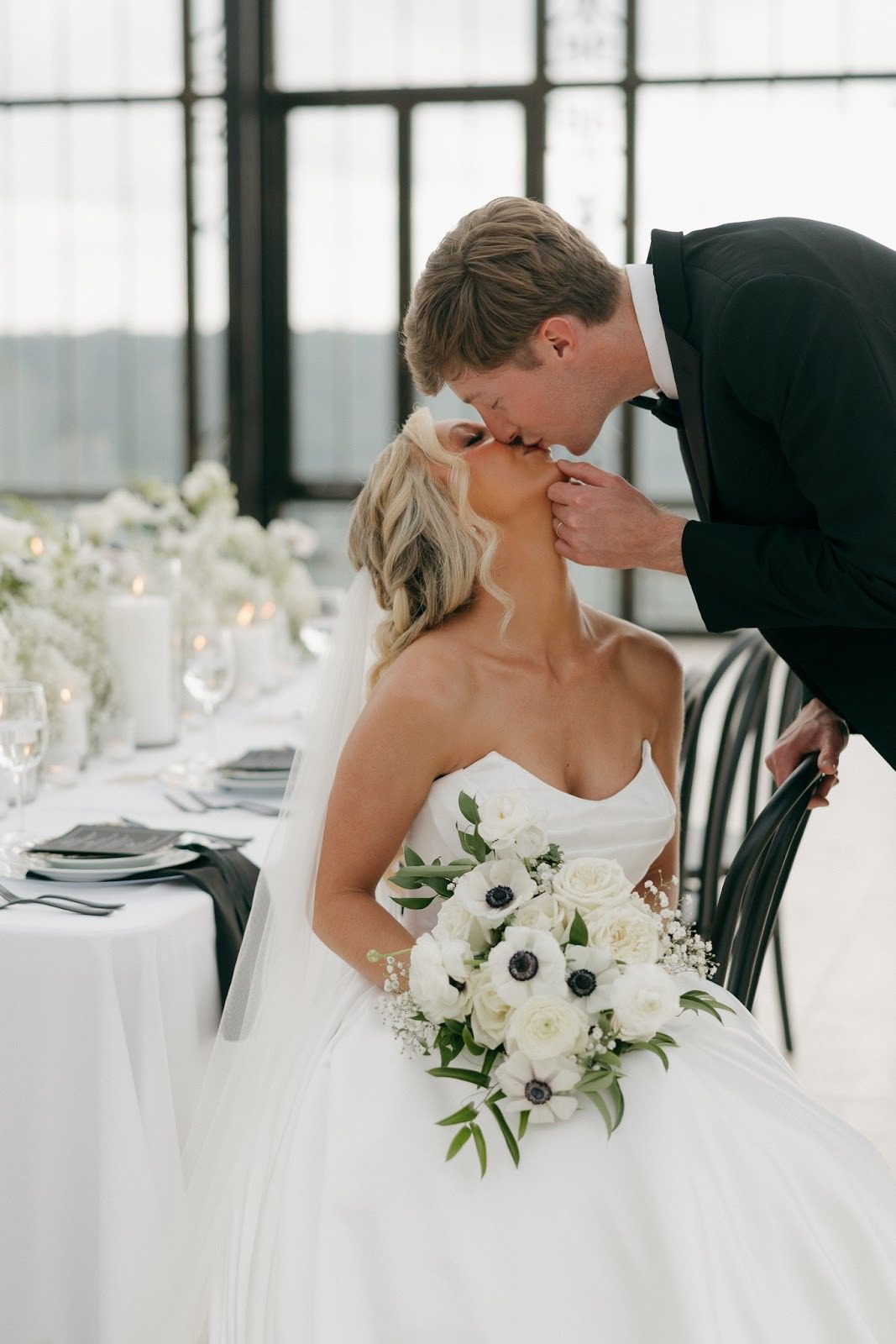 bride looking up to kiss her groom at stone haven weddings