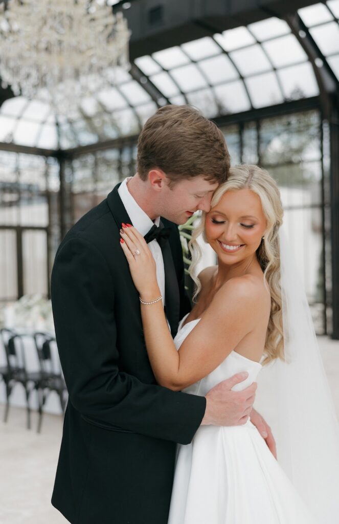 bride looking down while groom looks at her