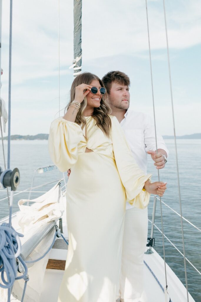 soon to be bride and groom on a boat across the water
