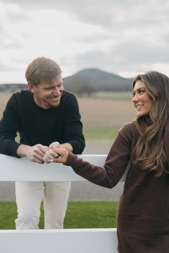 local couple holding hands during their engagement photos at Pursell farms